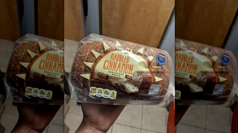Customer holding a bag of L'Oven Fresh Marbled Cinnamon Breakfast Bread