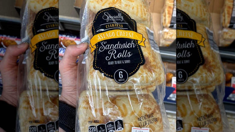 Customer holding a bag of Specially Selected Asiago Cheese Ciabatta Rolls