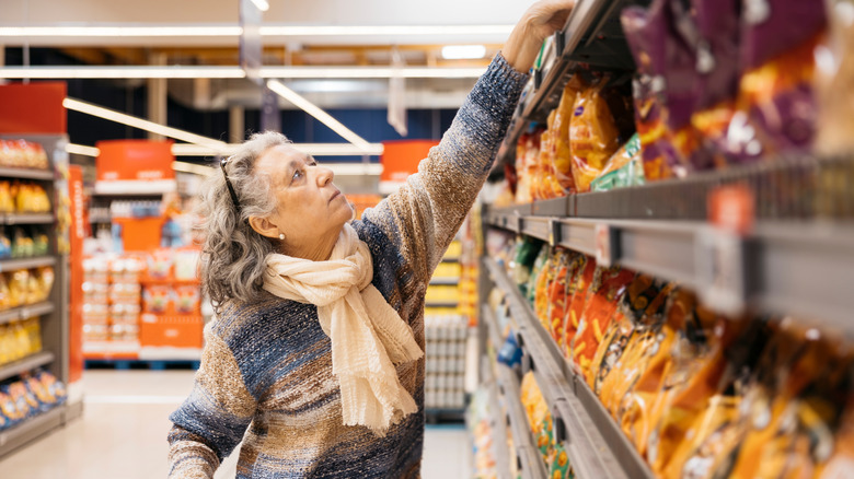 Woman placing item on shelf