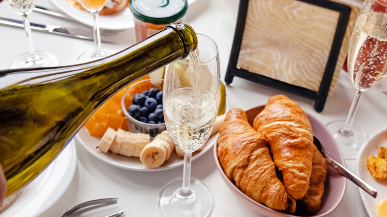 Glass of Champagne surrounded by brunch dishes