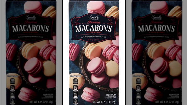 A box of macarons sits against a white background