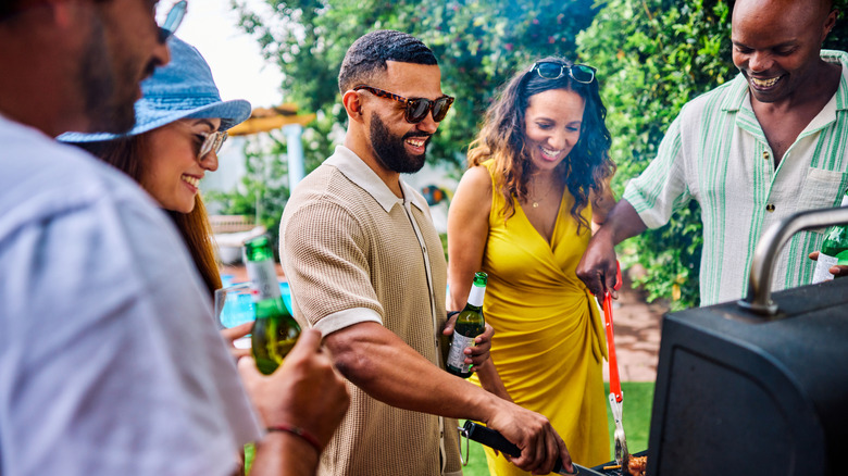 Friends gathered around a grill