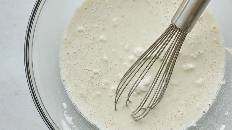 whisking batter in bowl