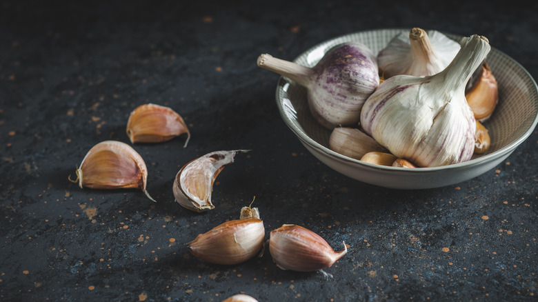 A bowl of garlic bulbs with cloves