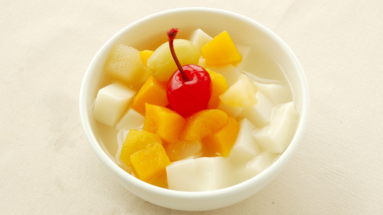 Bowl of Cantonese almond jelly with fruit cocktail