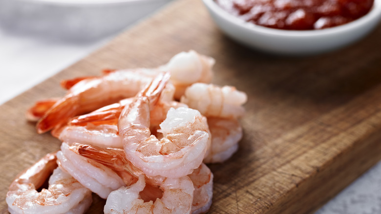 Fresh pink shrimp on wood block