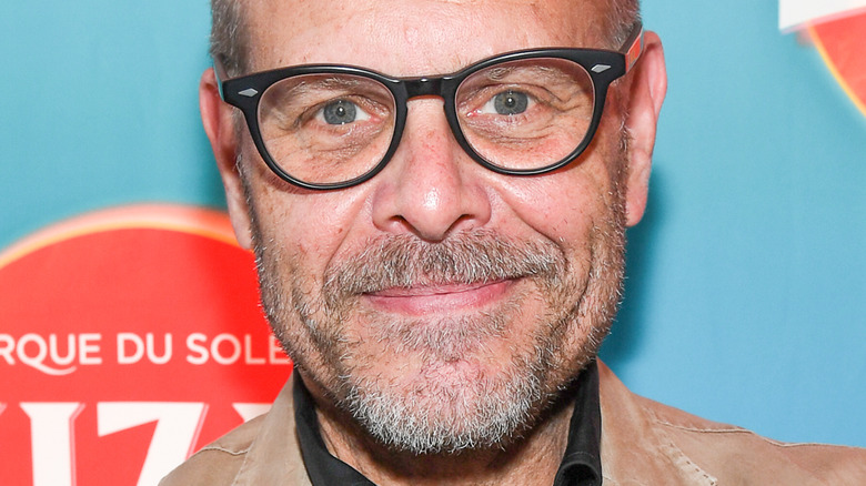 Alton Brown wearing glasses and smiling