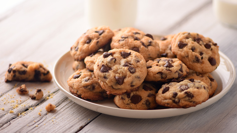plate stacked with chocolate chip cookies