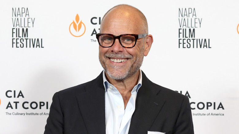 Alton Brown smiling at an event.