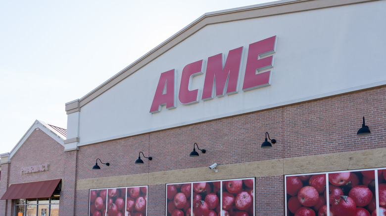 ACME store with brick exterior and images of apples in the windows