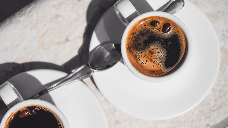 Top view of americano in white mug and saucer
