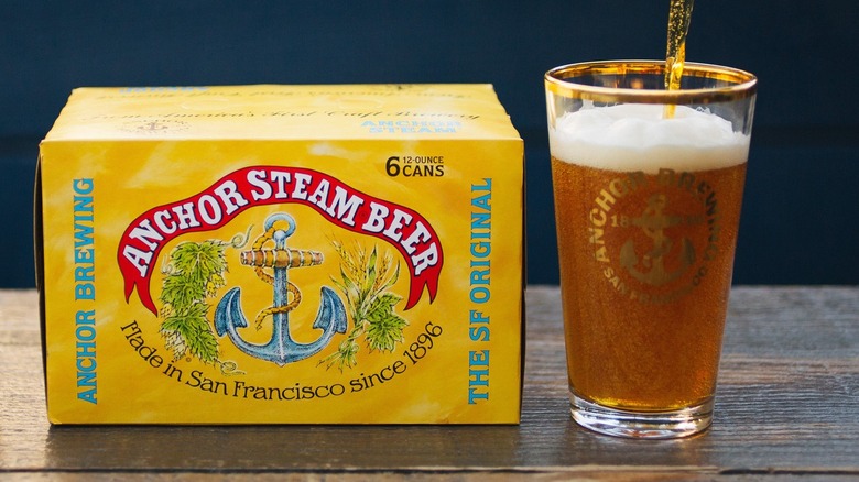 Six-pack of Anchor Brewing beer and a pint glass
