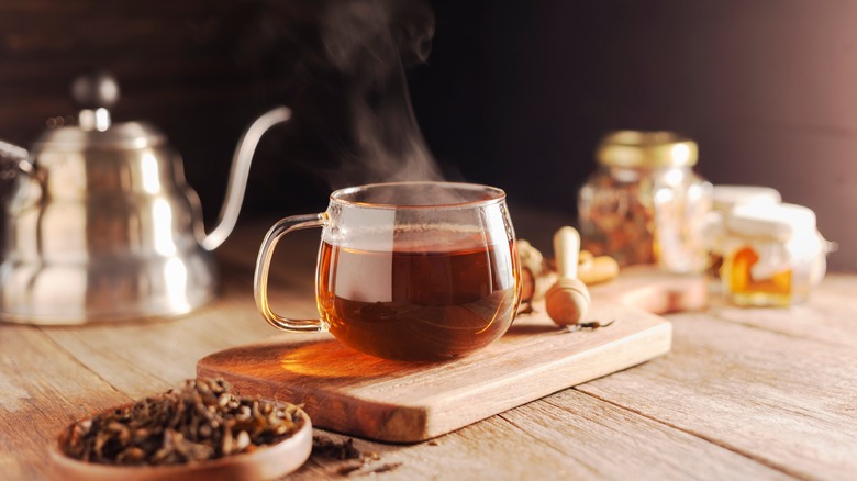 hot cup of tea next to kettle