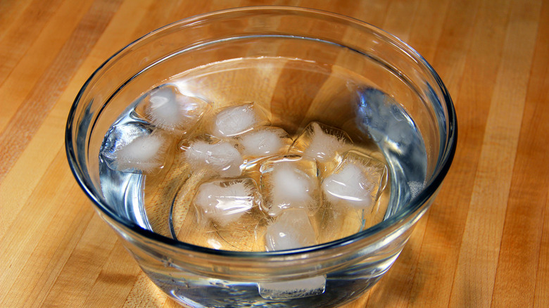 glass bowl with water and ice inside