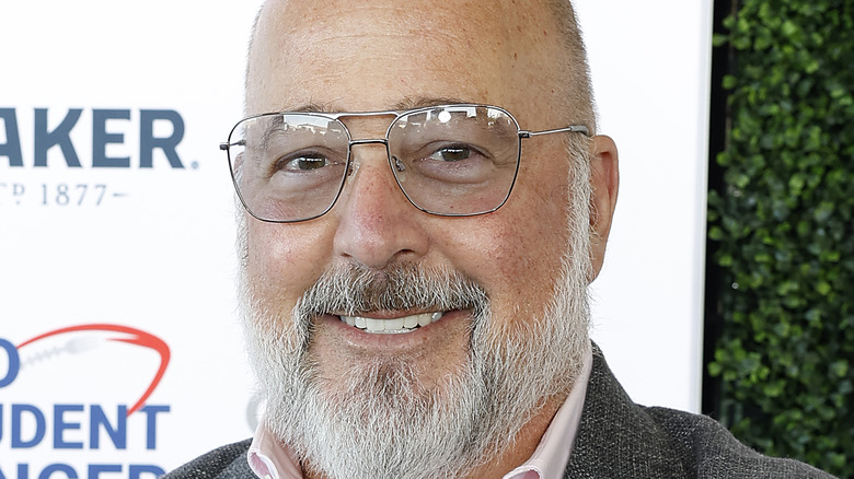 Andrew Zimmern smiling in glasses