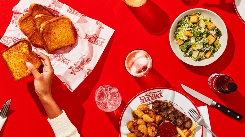 Various menu items from Sizzler against a red backdrop.