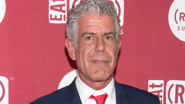 Anthony Bourdain posing on the red carpet at an event