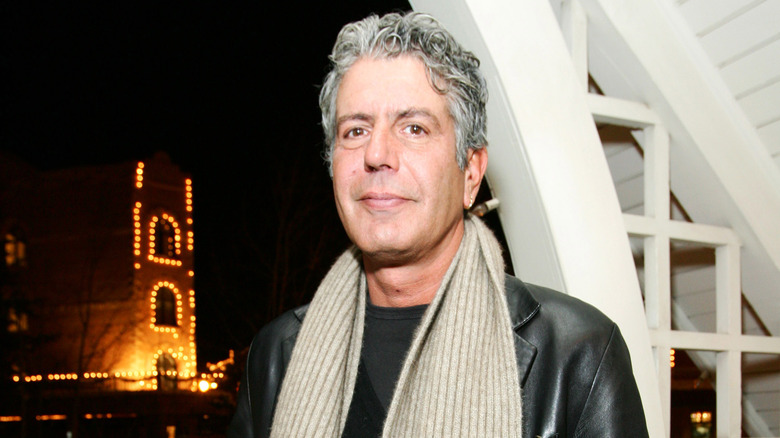 Anthony Bourdain wearing scarf and leather jacket