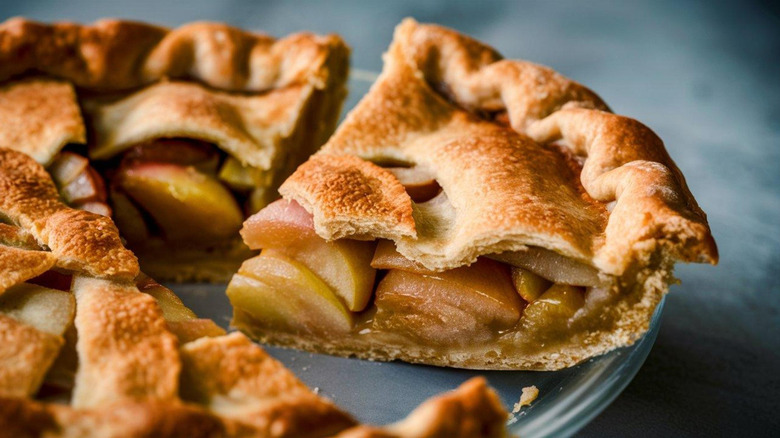 Apple pie sliced on a baking tray.