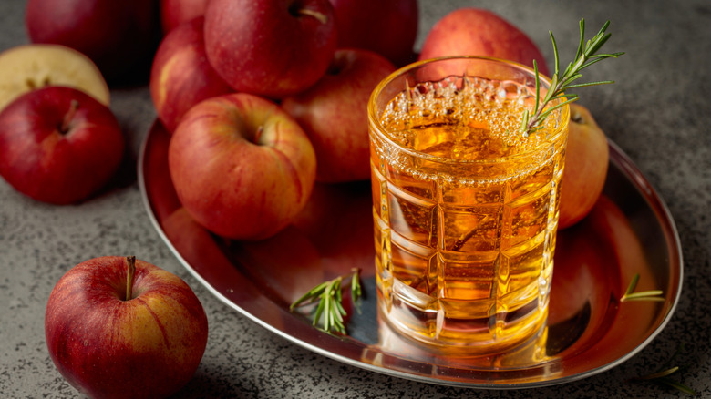 Apple drink garnished with rosemary.