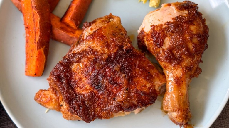 Applesauce barbecue chicken leg and thigh on plate with sides