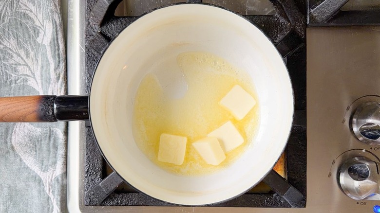 Butter melting in a saucepan on a stovetop