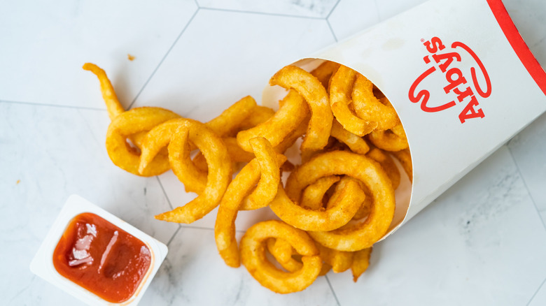Arby's curly fries with a side of ketchup.