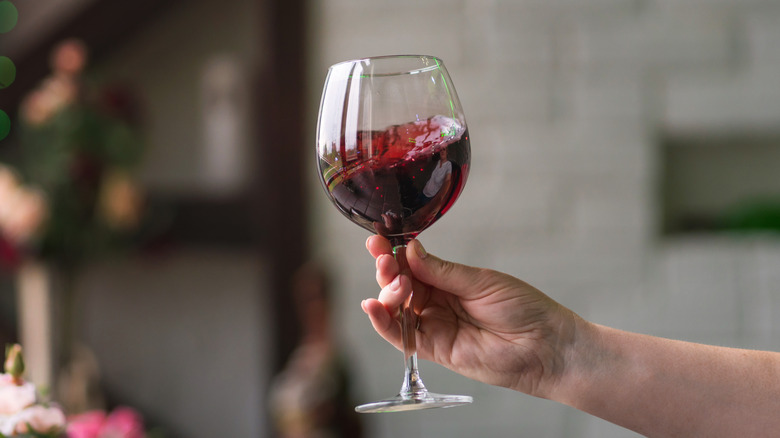 hand swirling glass of red wine 