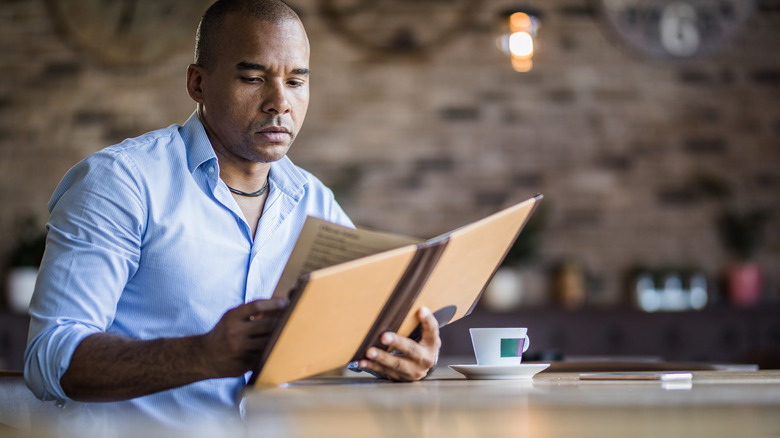 man looking at restaurant menu