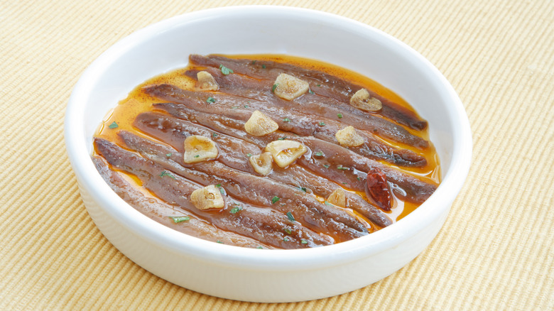A bowl of marinated anchovies in oil
