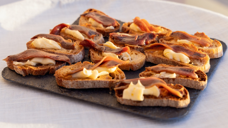 A plate of anchovies on toast