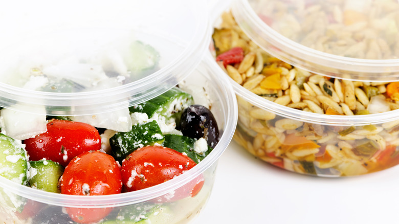 Deli containers filled orzo and a cucumber salad