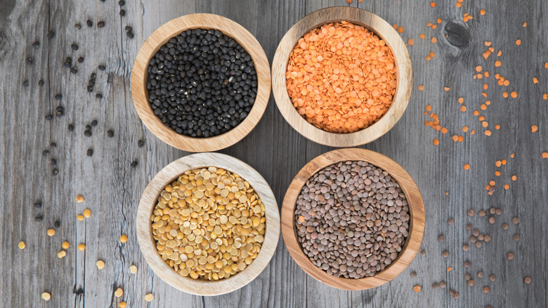 Four bowls holding different varieties of lentils