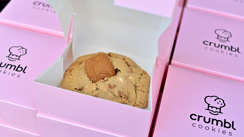 Several boxes of Crumbl cookies, with one open.