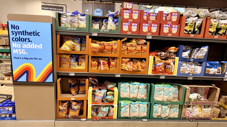 The interior of an Aldi with a sign about no synthetic colors.