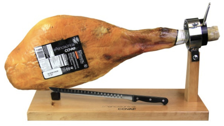 A Costco Covap Jamon Iberico Bellota Ham Leg on a wood stand with a knife