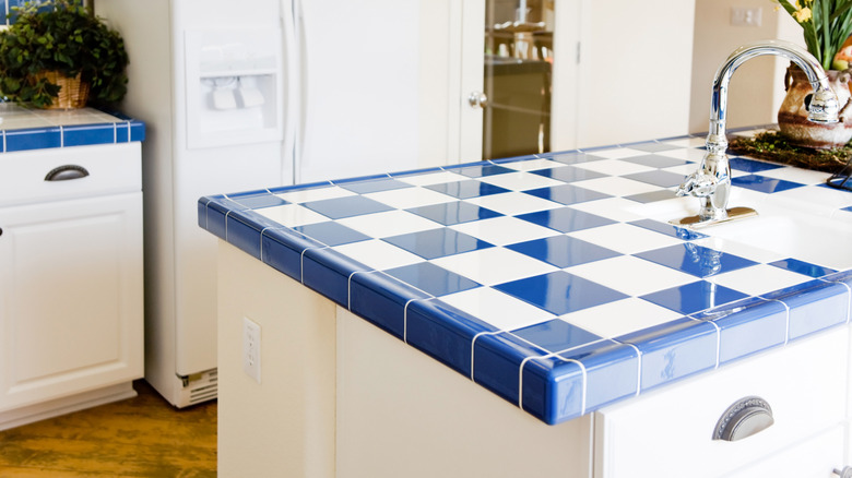 Modern kitchen with blue and white tiled countertop