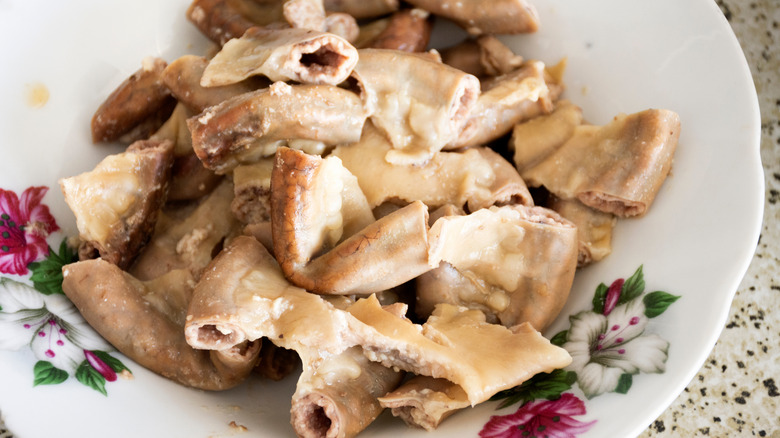 Chitterlings on a white bowl with flowers on it