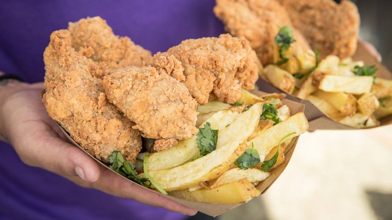 Vegan fried chicken with fries and fresh herbs