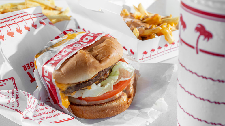In-N-Out burger, fries, and a drink in the red and white branded packaging
