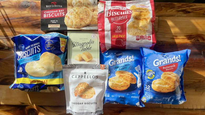 Various frozen biscuit brands displayed on a wooden surface