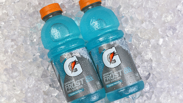 Two blue Gatorade bottles on ice.