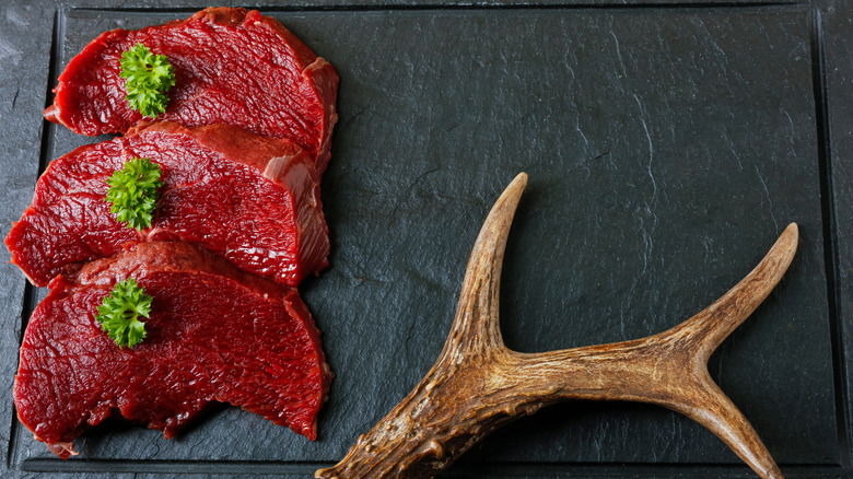 raw venison on a cutting board