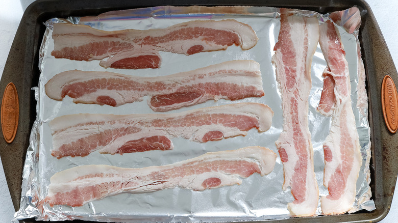 raw bacon on sheet pan