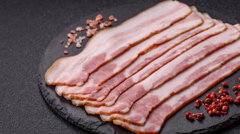 Raw bacon slices.