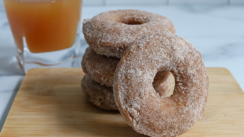 stacked sugar donuts and cider