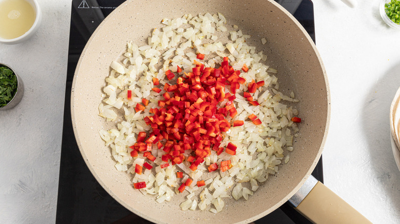 onions and peppers in pan