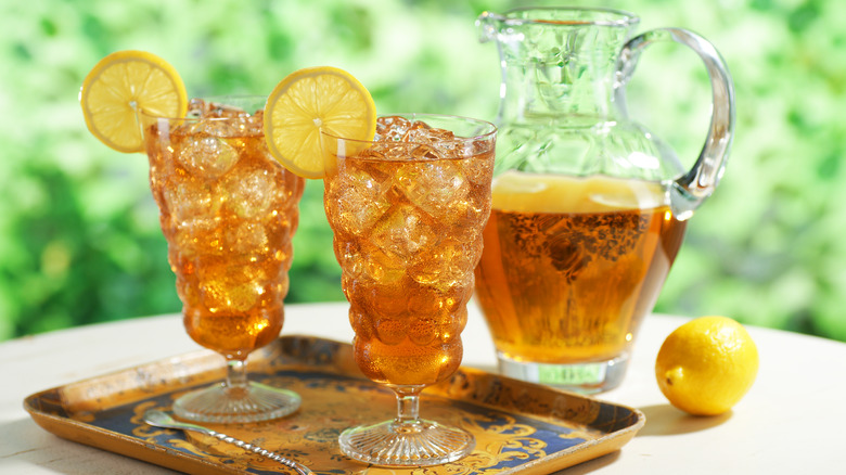 Pitcher and two glasses of iced tea with lemon
