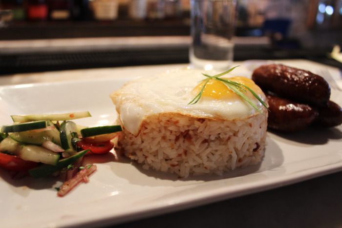 Maharlika's longsilog: garlic rice topped with a fried egg served with sweet garlic pork sausage and relish.