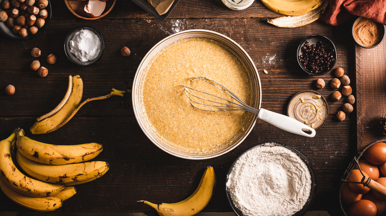 Bananas, nuts, and flour all on a table for baking